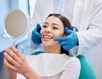 Woman smiling at reflection in mirror